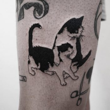 Two cats tattoo