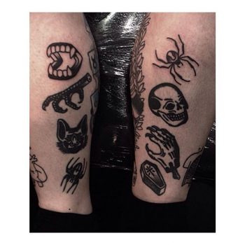 Various black tattoos on both calves