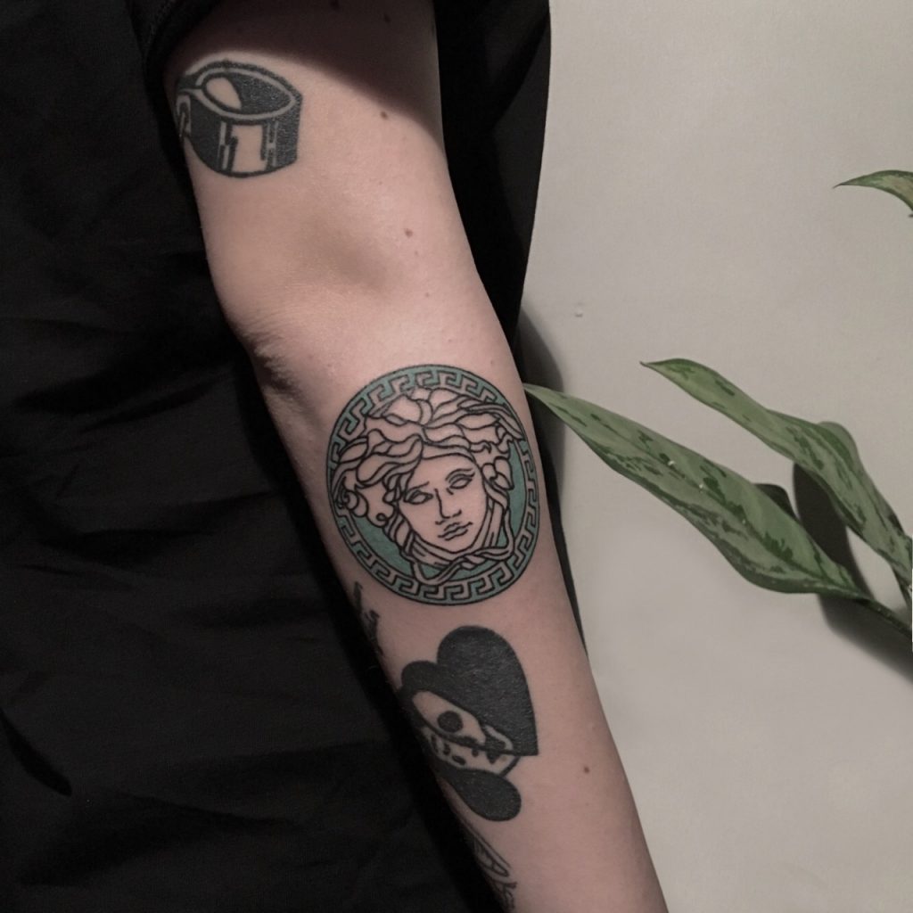 Versace logo tattoo by artist berkin dönmez