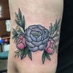 Violet and pink rose tattoo on the arm