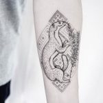 Weasel tattoo on the forearm