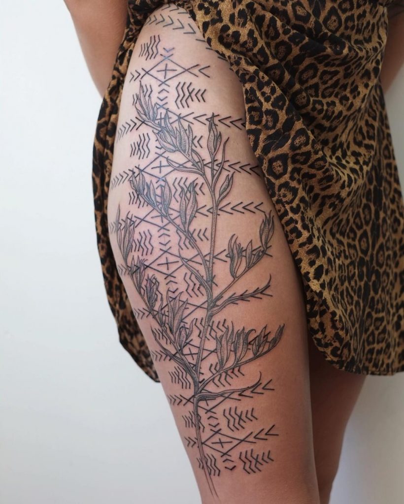 Wild plant and ornament tattoo on the thigh