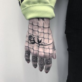 Wired fence and black rose tattoo