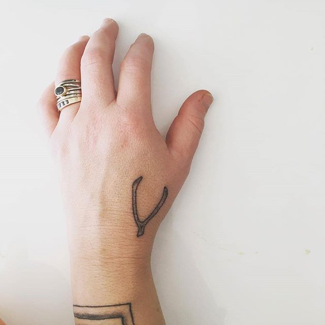 Wishbone tattoo on the left hand