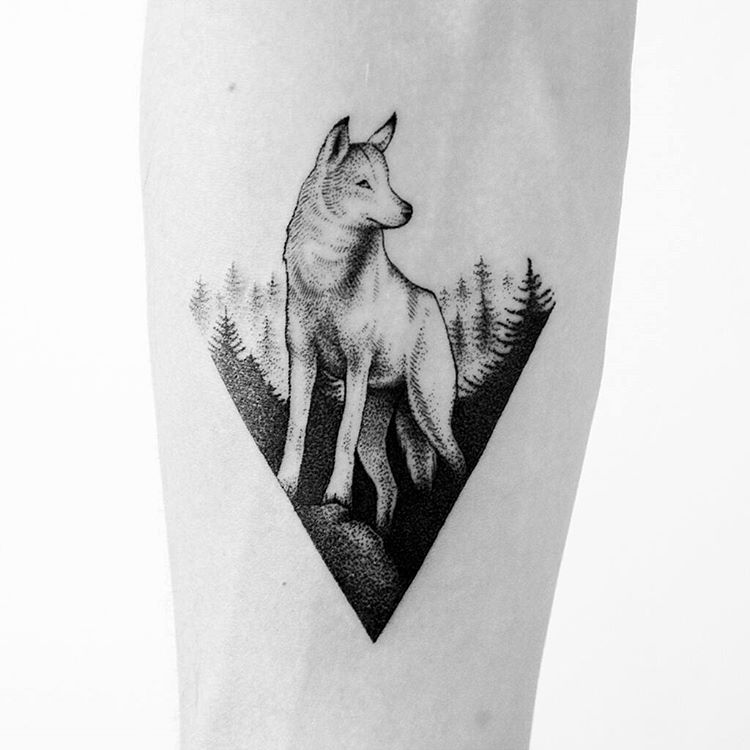 Wolf in a triangle tattoo