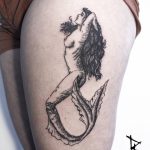 Woodcut style mermaid tattoo