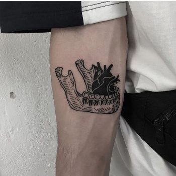 Woodcut mandible and heart tattoo
