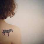 Zebra tattoo on rihgt shoulder blade