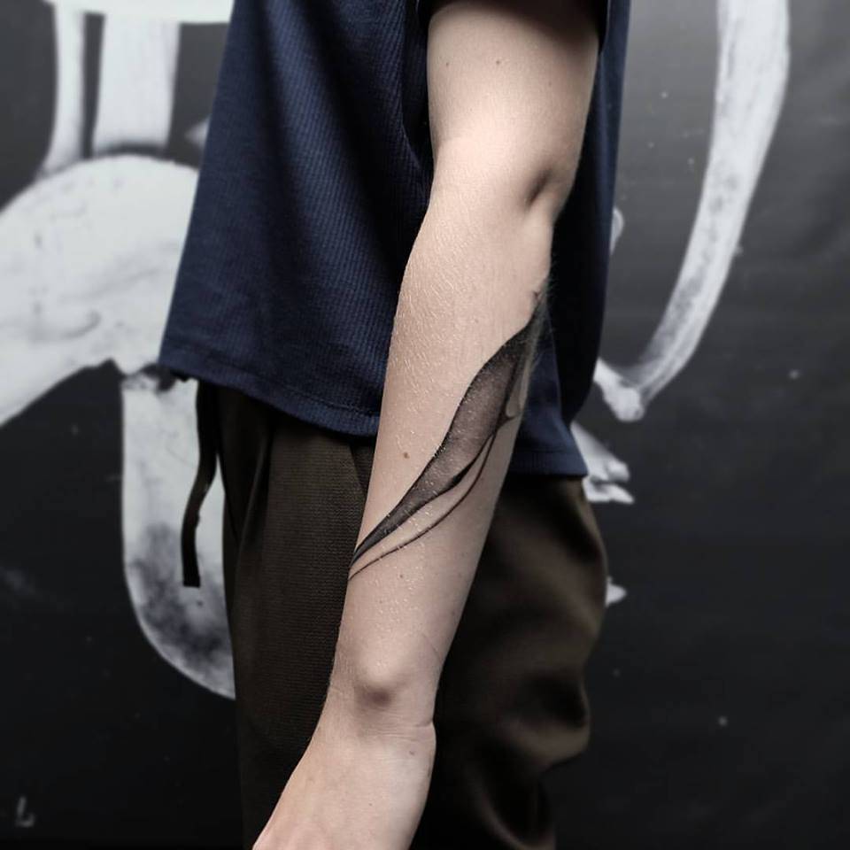 Abstract blackwork tattoo on the forearm