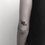 Beautiful black snake by stick around tattoo