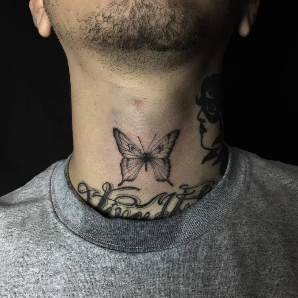 Black butterfly tattoo on the neck