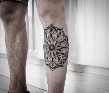 Black mandala tattoo on the shin