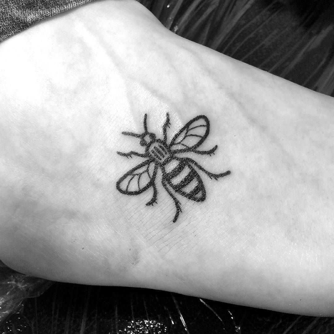 Black solid bee tattoo