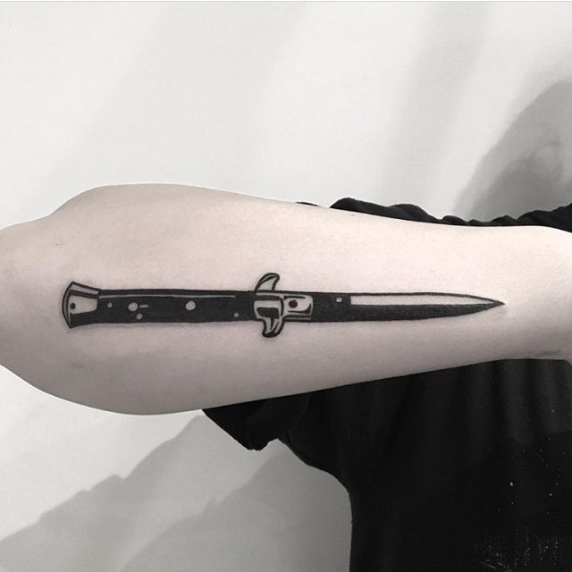 Black switchblade tattoo by noil culture 