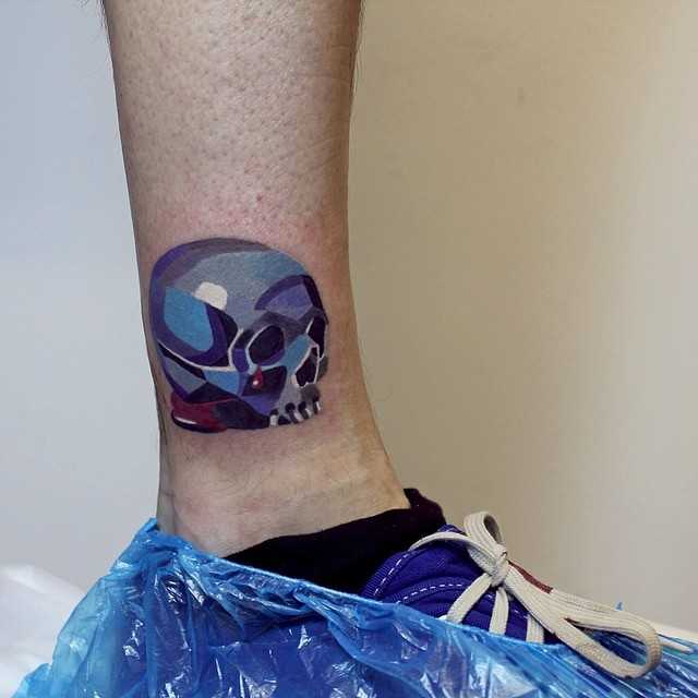 Colorful skull tattoo on the ankle