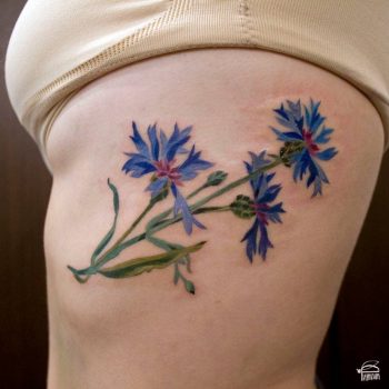 Cornflower tattoo on the rib cage