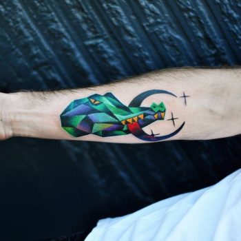 Crocodile with a crescent moon tattoo