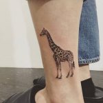 Giraffe tattoo on the left calf