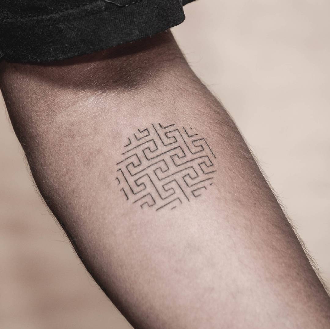 Hand poked circular maze tattoo