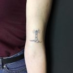 Hand poked lighthouse tattoo