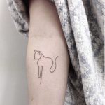 Hand poked linear cat tattoo