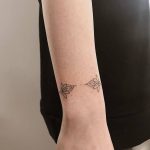 Hand poked lotus flower bracelet tattoo