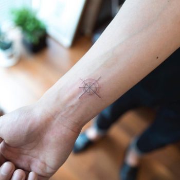 Hand poked small compass tattoo