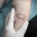 Hand poked tiny pig tattoo