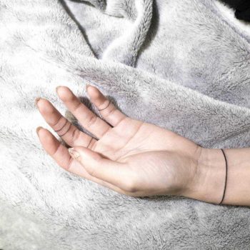Hand poked wristband tattoo