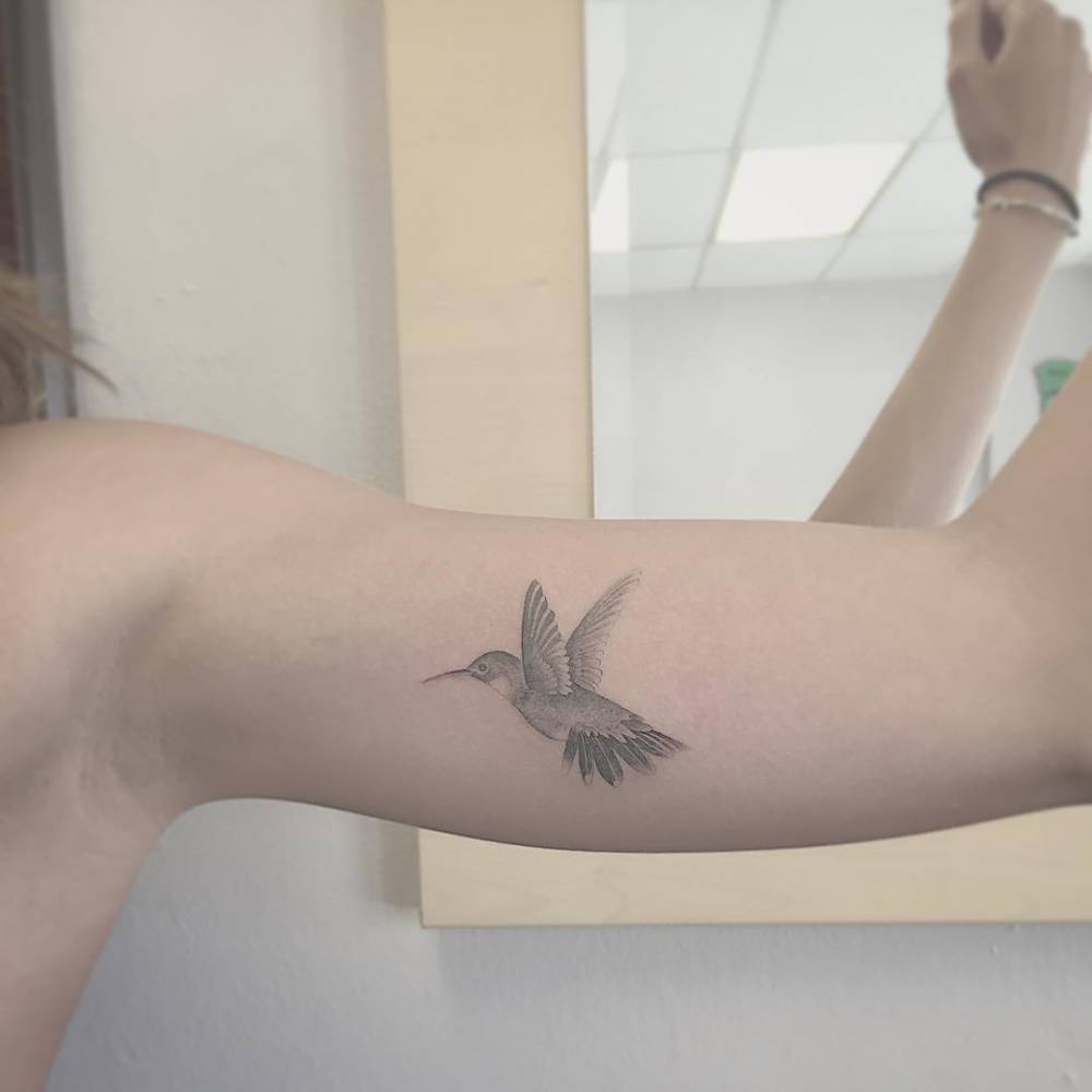Hummingbird tattoo on the bicep
