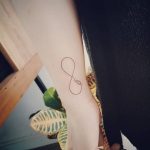 Infinity symbol tattoo on the forearm