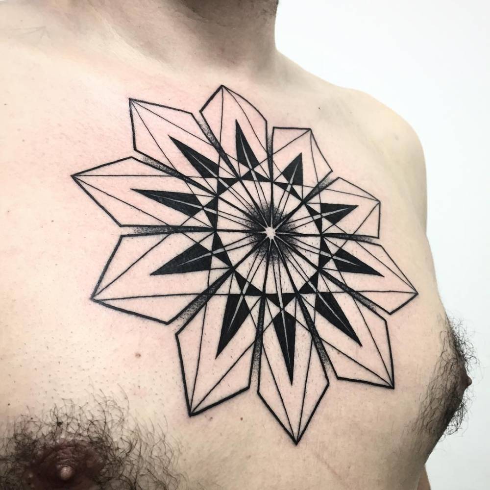 Large geometric mandala tattoo on the chest