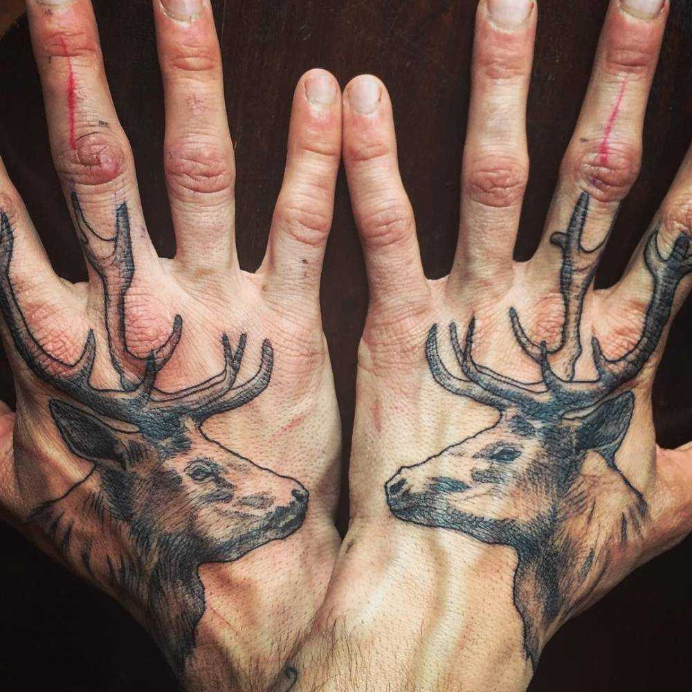 Matching deer tattoos on both hands