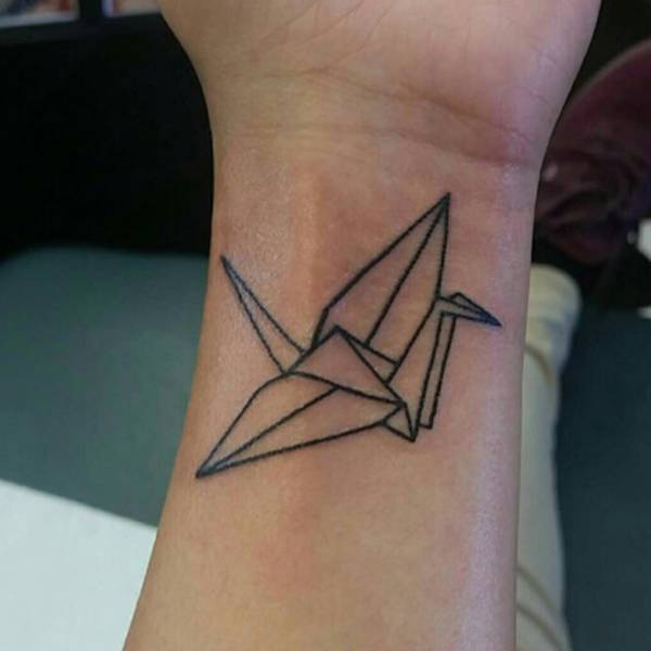 Paper crane on the wrist