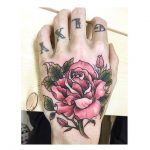 Pink rose tattoo on the left hand