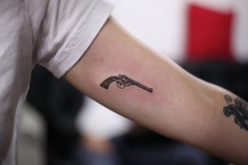 Small gun tattoo