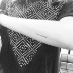 Small needle tattoo on the forearm