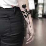 Solid black rose by slumdog tattooer
