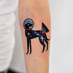 Space greyhound tattoo on the forearm
