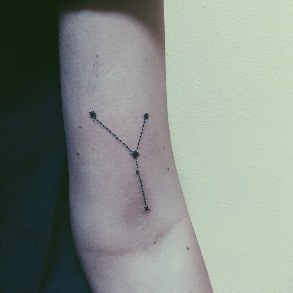 Taurus constellation tattoo on the left arm
