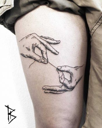 Thread holding hands tattoo