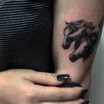 Three horse heads tattoo