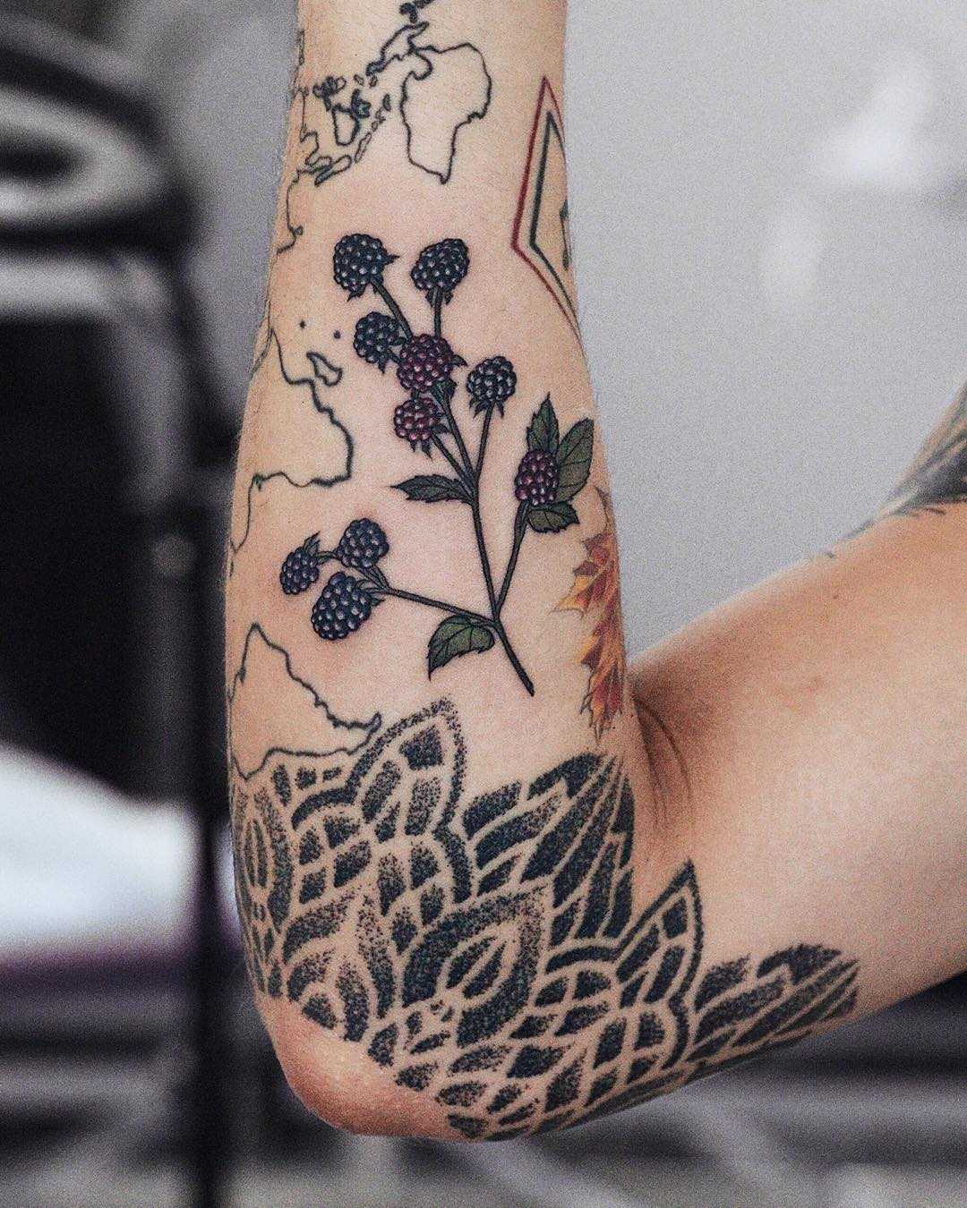 Tiny blackberry tattoo on the forearm