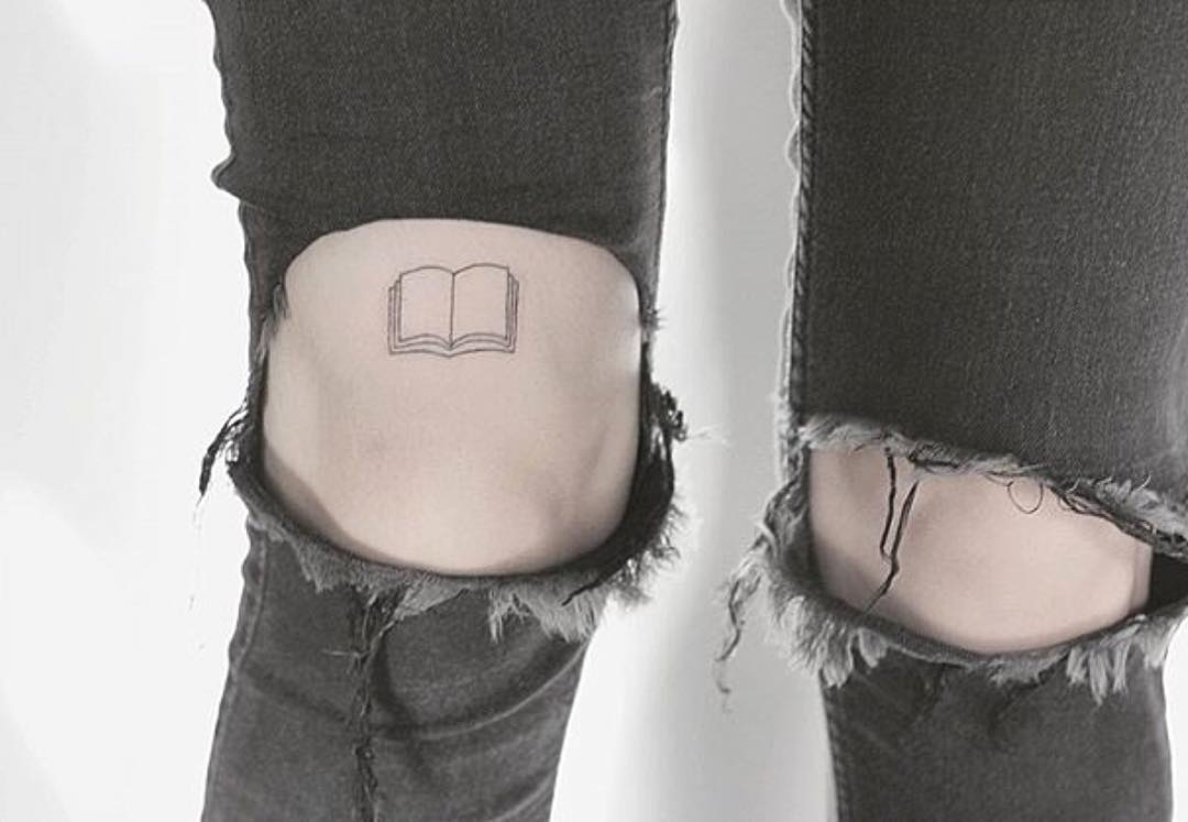 Tiny book tattoo by lindsay april