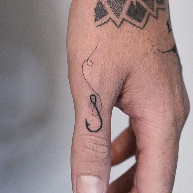 Tiny hook tattoo