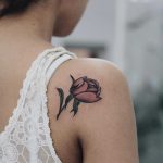 Tiny peony tattoo on the shoulder