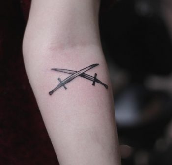 Two swords tattoo done by kristian kriistian