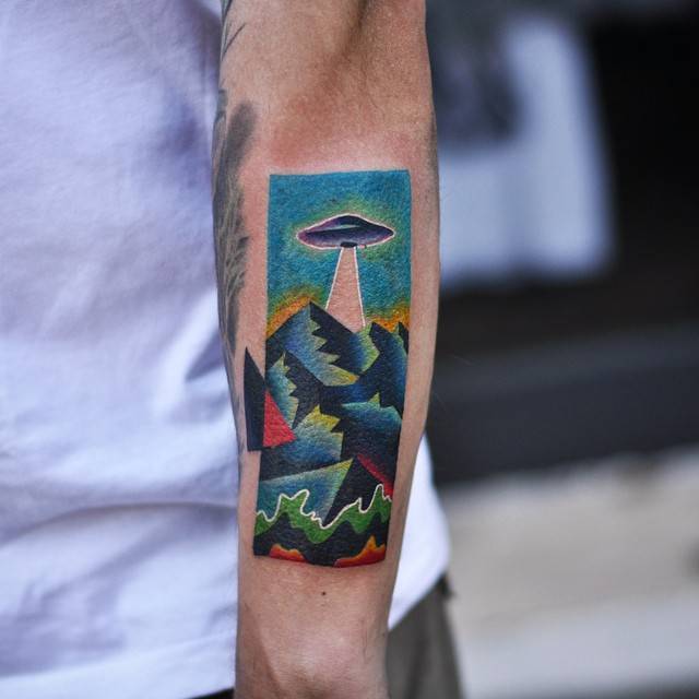 Ufo above mountains tattoo