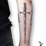 Woodcut style sword tattoo