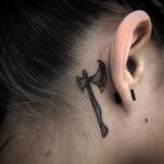 Ax tattoo behind the right ear